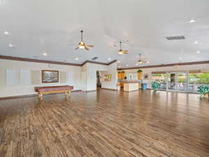 Recreation room with ornamental molding, lofted ceiling, hardwood / wood-style flooring, and billiards