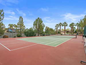 Tennis court featuring basketball hoop