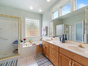 Bathroom with vanity, tile patterned floors, and shower with separate bathtub