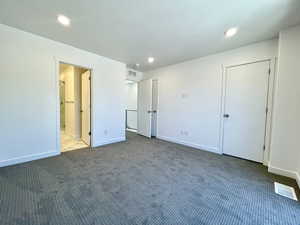 Spacious and serene primary suite with plenty of natural light.