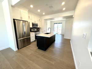 A sleek, modern kitchen with a spacious island, perfect for entertaining and gathering with loved ones. The open-concept design flows seamlessly into the living area, making it an ideal space for dinner parties or casual get-togethers.