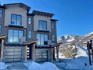 Contemporary home featuring a garage and a mountain view