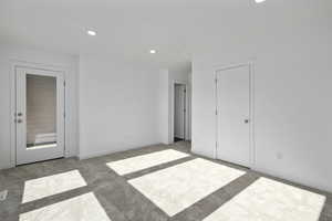 Unfurnished bedroom with light colored carpet