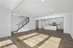 Unfurnished living room with dark hardwood / wood-style floors