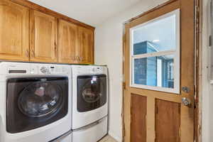 Laundry area with cabinets and washing machine and dryer