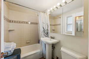 Bathroom featuring toilet and shower / tub combo