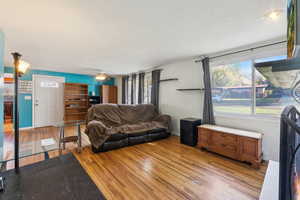 Living room with light wood-type flooring and ceiling fan