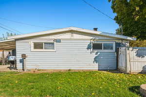 View of property exterior featuring a lawn