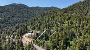 View of mountain backdrop featuring a heavily wooded area
