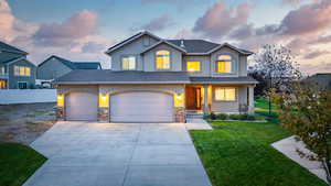 Front facade featuring a garage and a yard