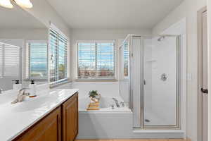 Bathroom featuring vanity, tile patterned floors, and independent shower and bath