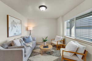 Living room with wood-type flooring and a textured ceiling