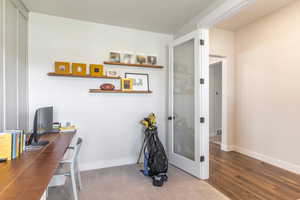 Office area with dark hardwood / wood-style floors