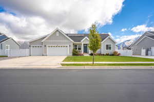 View of front facade featuring a garage, a front yard, and a mountain view