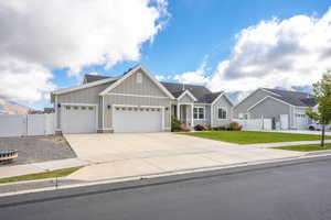 View of front of property with a front lawn and a garage