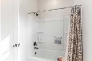 Bathroom featuring shower / bath combo with shower curtain