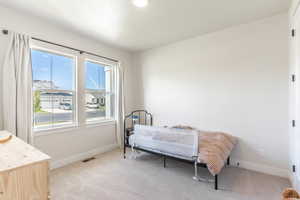 Bedroom with light colored carpet