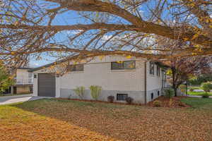 View of front of house featuring a garage and a front lawn