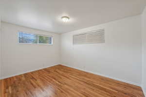 Primary bedroom with hardwood floors