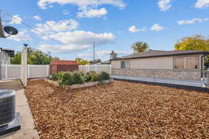 View of yard featuring a patio area, cooling unit, and a storage shed