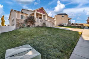 View of front of house featuring a garage and a front lawn