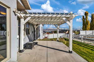 View of patio with a pergola and a mountain view