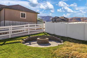 View of yard with a mountain view, an outdoor fire pit, and a patio area