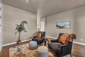 Sitting room featuring dark wood-type flooring