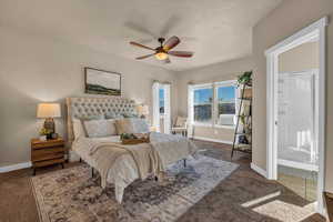 Bedroom with ceiling fan and dark carpet