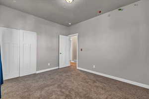 Unfurnished bedroom featuring carpet