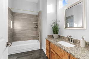 Bathroom with vanity and tiled shower / bath combo