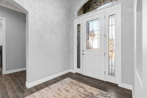 Entryway with dark hardwood / wood-style flooring