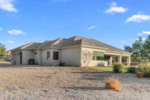 Rear view of property with central AC