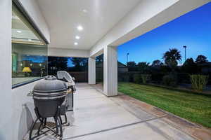 Patio terrace at dusk with a yard