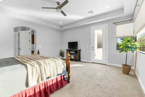 Bedroom with a fireplace, access to outside, ceiling fan, and carpet floors