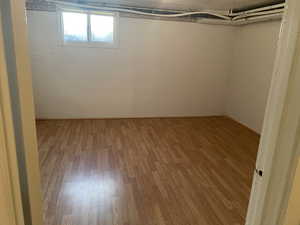 Basement featuring light wood-type flooring