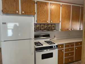 Kitchen featuring white appliances