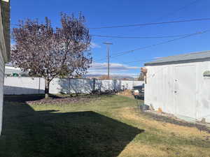 View of yard with a storage unit