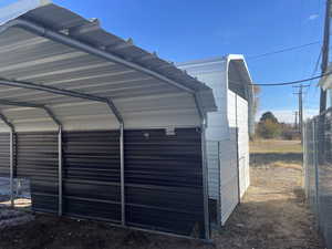 Garage featuring a carport