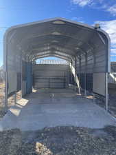 View of vehicle parking featuring a carport