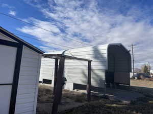 View of outbuilding with a carport