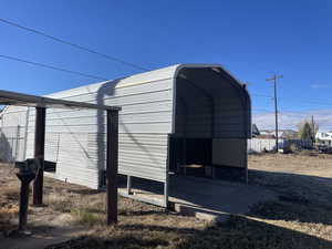 View of outbuilding with a carport