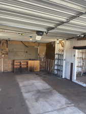 Garage with a garage door opener and a workshop area