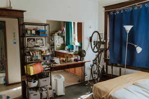 Carpeted bedroom with a workshop area