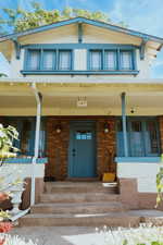 View of exterior entry featuring a porch