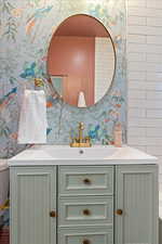 Bathroom featuring designer tile, floating vanity, Graham & Brown Wallpaper and solid brass faucet