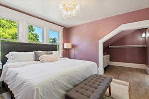 Master bedroom featuring designer lighting, medallion, walk through closet,  and bright lighting