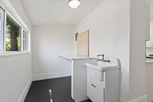 Laundry area/ Mudroom with Utility sink, and Quartz countertops