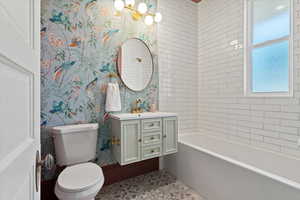 Bathroom featuring designer tile, floating vanity, Graham & Brown Wallpaper and solid brass faucet