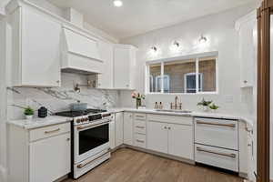 Kitchen Area with Cafe appliances, double drawer dishwasher, Custom cabinets in custom color, Solid brass faucets, and exquisite lighting.